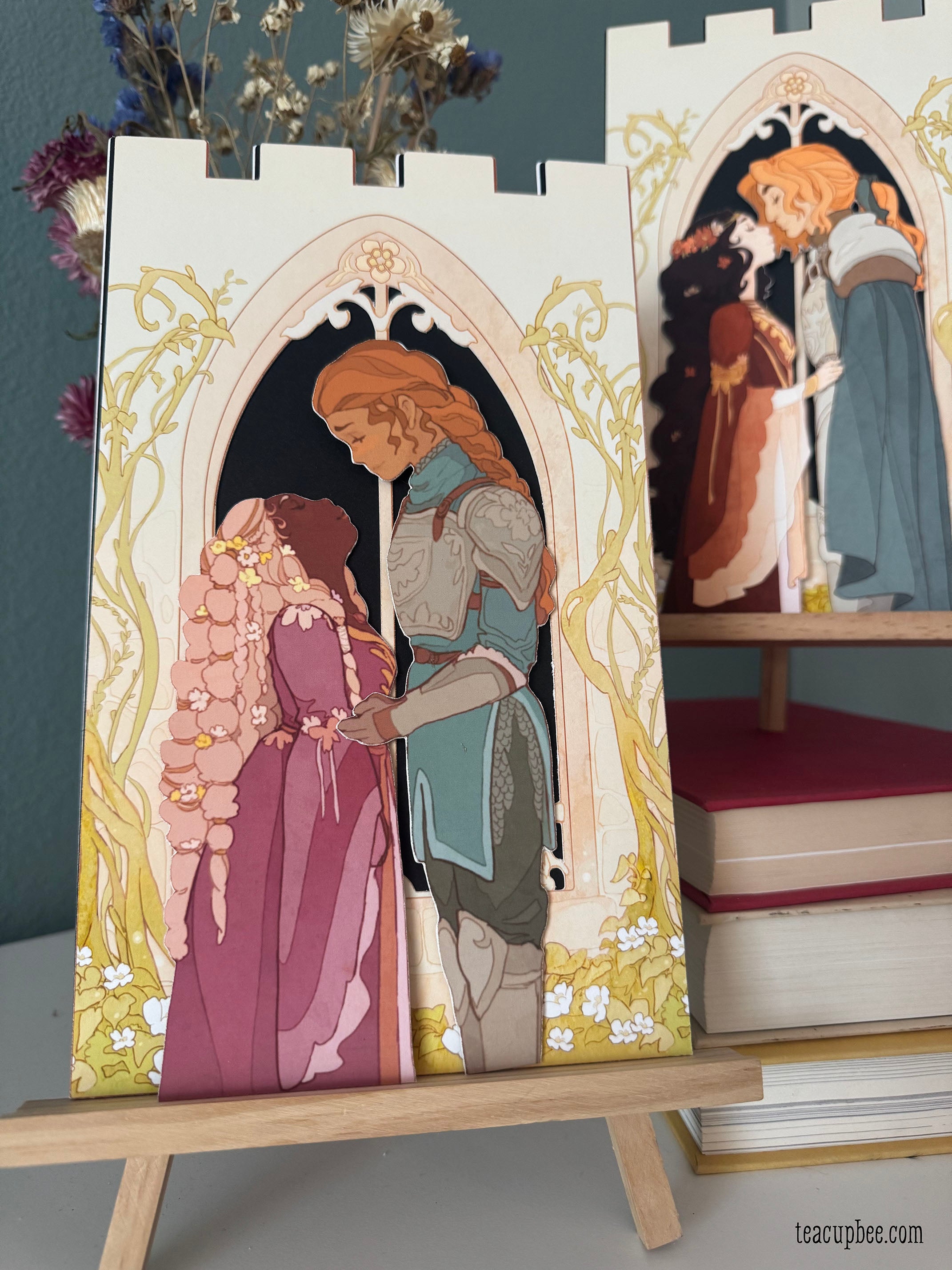 bookmark Illustrations of a couple in a decorative frame on an easel with books in the background.