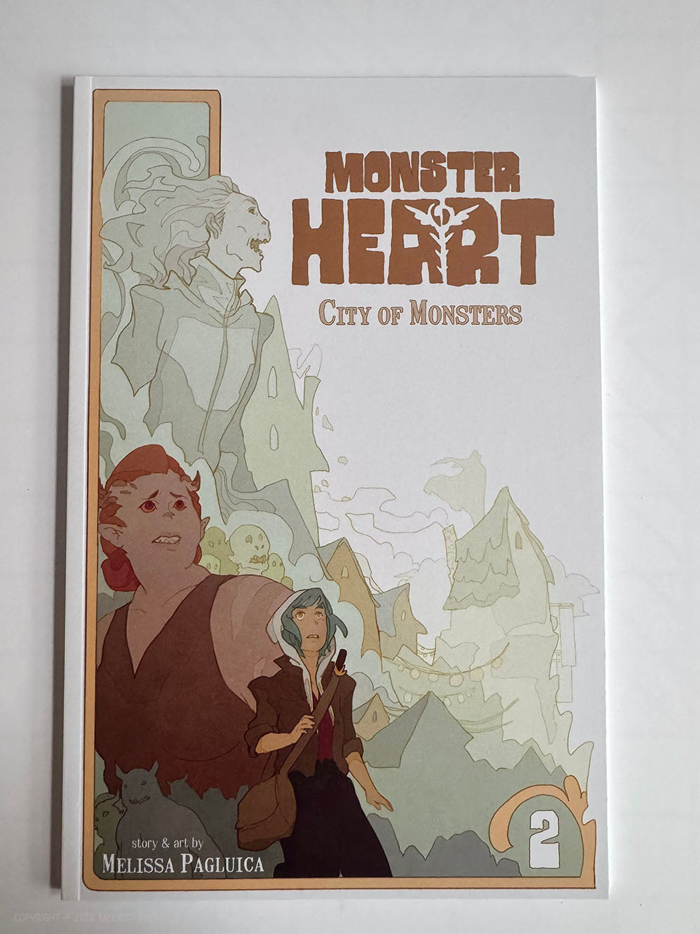 Book cover of 'Monster Heart: City of Monsters' (book 2) with illustrations and text on a white background