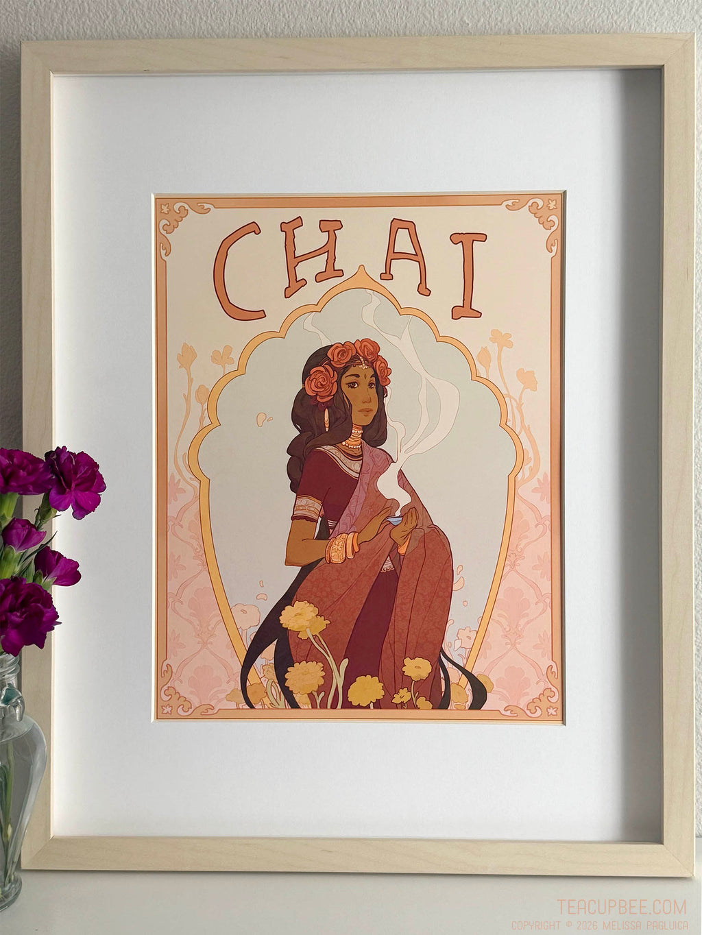 Framed artwork with a woman in a sari and the word 'Chai' above her.