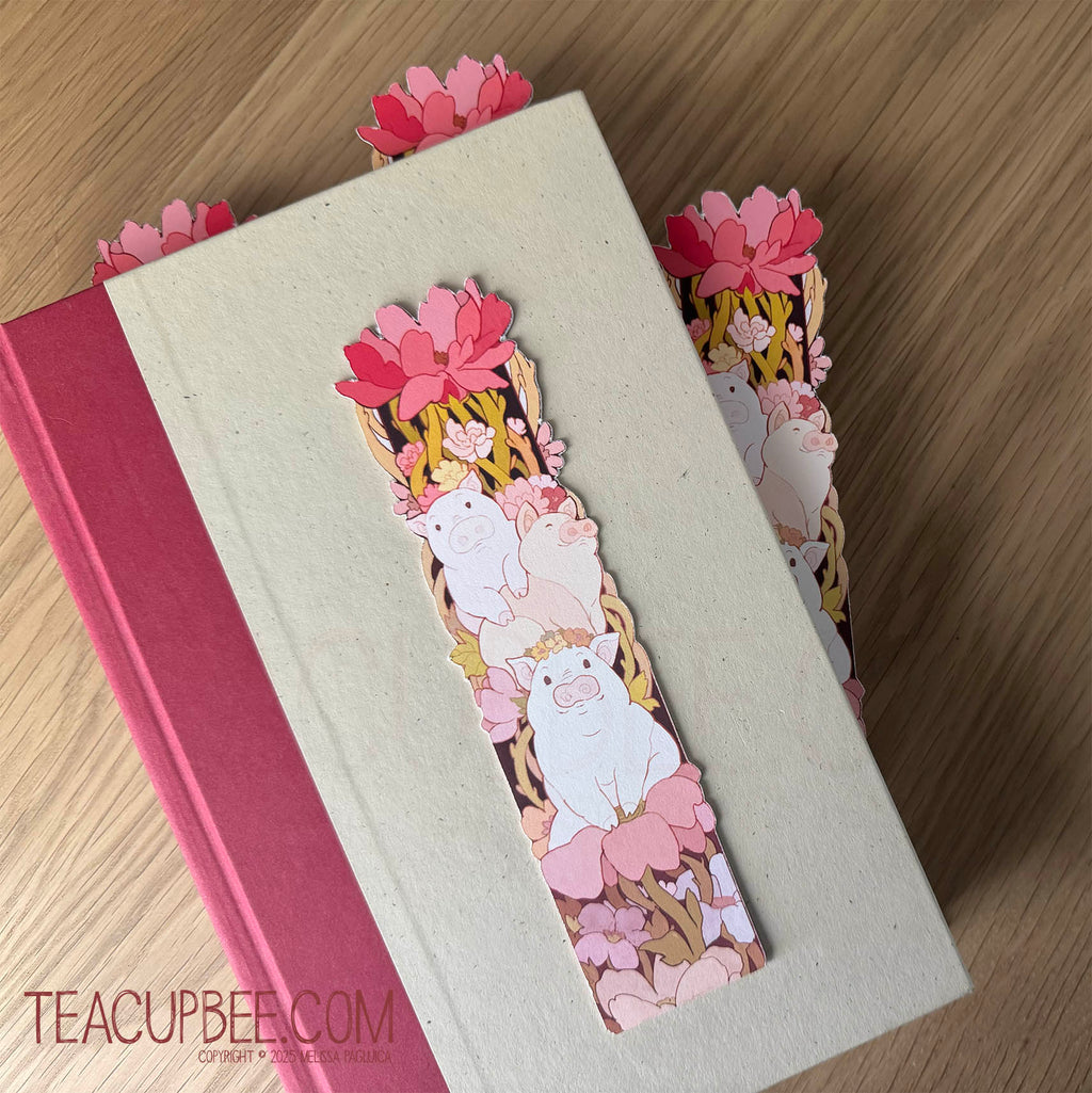 Bookmark with piggy and flower design on a book