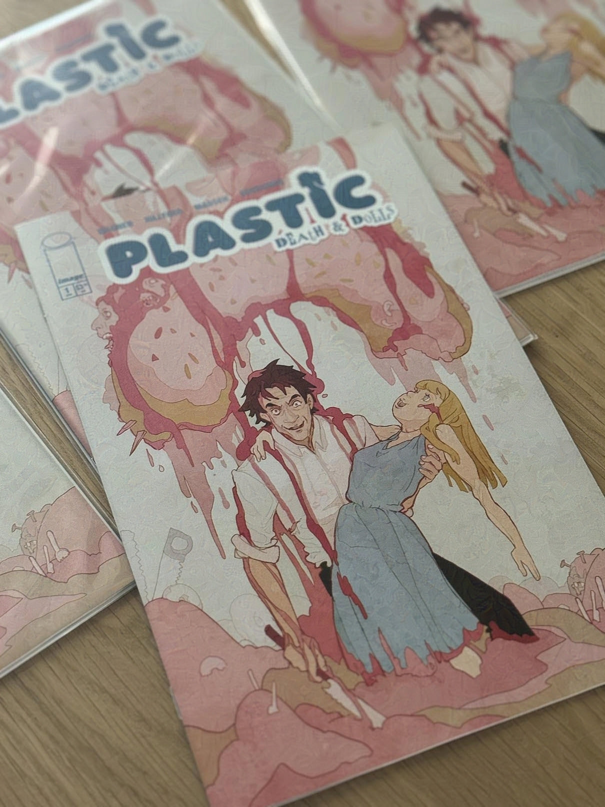 Comic book titled 'Plastic' with colorful artwork on a wooden surface